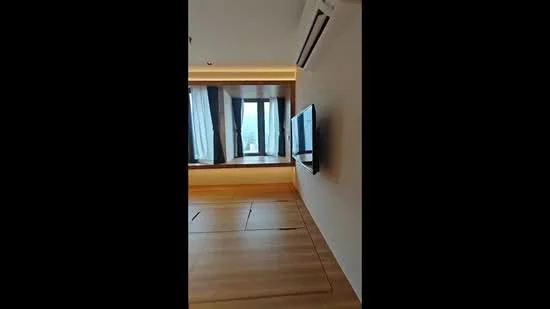 Room features: wooden flooring, floor-to-ceiling windows, wall-mounted TV, air conditioning unit, sheer curtains, recessed lighting, neutral painted walls, built-in cabinetry; style: modern; view: city.