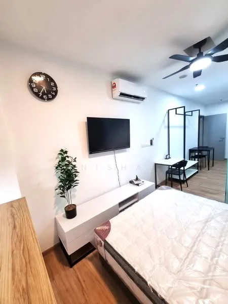 Bedroom features: wooden flooring, white painted walls, 5-blade ceiling fan with light, wall-mounted TV, white TV console, decorative plant in pot, clock on wall, window with natural light, study desk with chair, bed with mattress; style: modern.