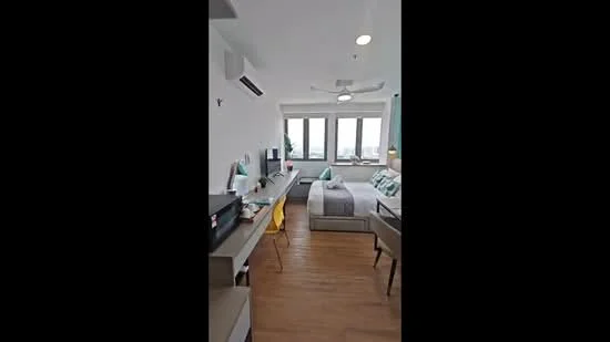 Bedroom features: queen-size bed, upholstered headboard, 2 bedside lamps, study desk with chair, wall-mounted TV, floor-to-ceiling windows, wooden flooring, 5-blade ceiling fan with light, decorative wall art, built-in wardrobe; style: modern; view: city.