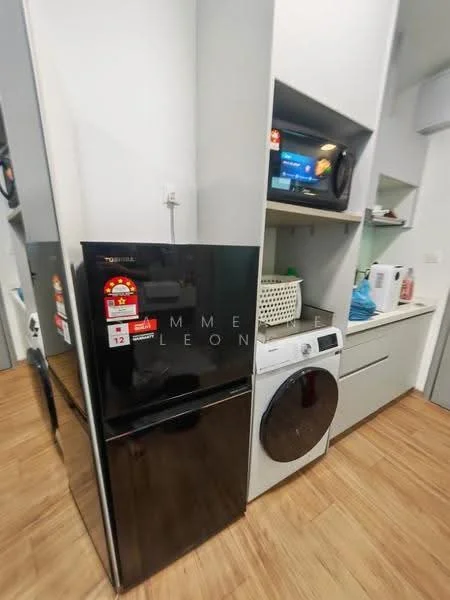 Room features: black fridge, front-load washing machine, microwave, white cabinetry, wooden flooring, countertop, basket for storage, appliances on shelves; style: modern.