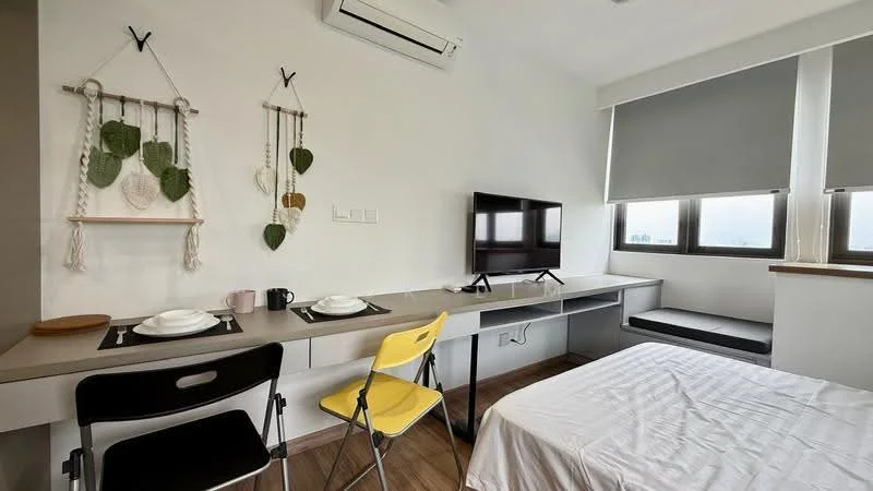 Room features: white painted walls, wooden flooring, 1 wall-mounted split AC, 2 windows with roller blinds, TV on wall-mounted bracket, grey dining table with 2 chairs, black folding chair, bed with white bedding, built-in desk with storage, decorative wall hangings; style: modern; view: city.