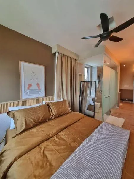 Bedroom features: king-size bed with brown bedding, upholstered headboard, decorative throw blanket, floor-to-ceiling windows, sheer curtains, wooden flooring, 5-blade ceiling fan, framed artwork on wall, full-length mirror, glass partition to bathroom, nightstand, table lamp; style: modern.