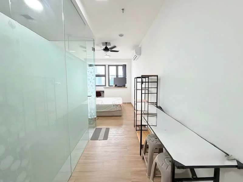 Room features: glass partition wall, wooden flooring, ceiling fan, wall-mounted air conditioning unit, large window, white painted walls, table with stools, bed visible in background; style: modern.