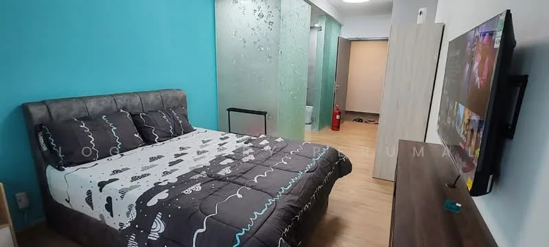 Bedroom features: queen-size bed with grey upholstered headboard, black and white patterned bedding, light blue accent wall, wooden flooring, wall-mounted TV, wooden TV console, decorative wall with glass panels, fire extinguisher visible, doorway leading to another room; style: modern.