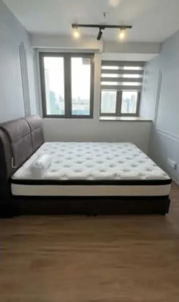 Bedroom features: king-size bed, upholstered headboard, wooden flooring, floor-to-ceiling windows, roller blinds, track lighting, white painted walls, decorative wall paneling; style: modern; view: city.