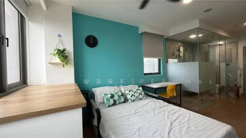 Bedroom features: single bed, wooden bedside table, green accent wall, white painted walls, ceiling fan, floor-to-ceiling window, decorative wall clock, green and white patterned throw pillows, wooden countertop, yellow chair, glass shower enclosure; style: modern.