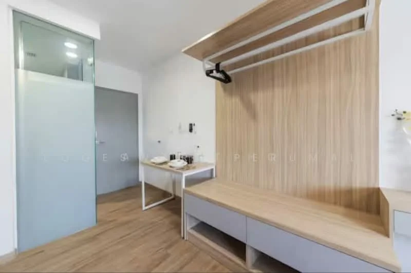 Room features: wooden flooring, light wood wall paneling, glass sliding door, white walls, built-in bench with storage, wall-mounted coat rack, table with minimalistic design, ambient lighting; style: modern.