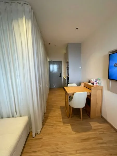 Room features: light wood flooring, white walls, curtains, dining table with chairs, wall-mounted TV, open kitchen area, recessed lighting, doorway, decorative items on table; style: modern.