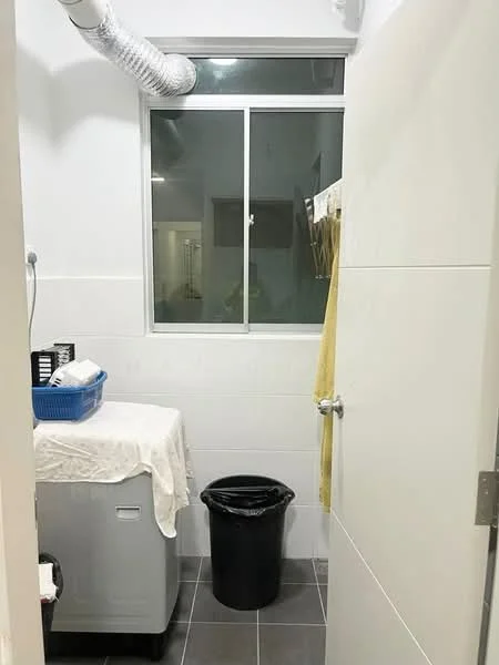 Laundry features: front-load washing machine, white countertop, black trash bin, window with clear glass, grey tiled flooring, white tiled walls, hanging rack for clothes, basket for laundry.