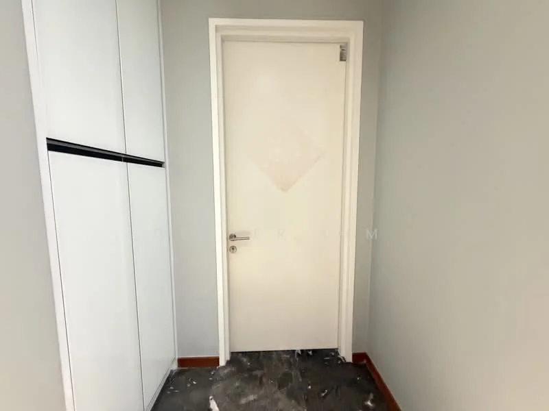 Room features: white painted walls, grey flooring, white door, built-in wardrobe with black accents, trimmed door frame.