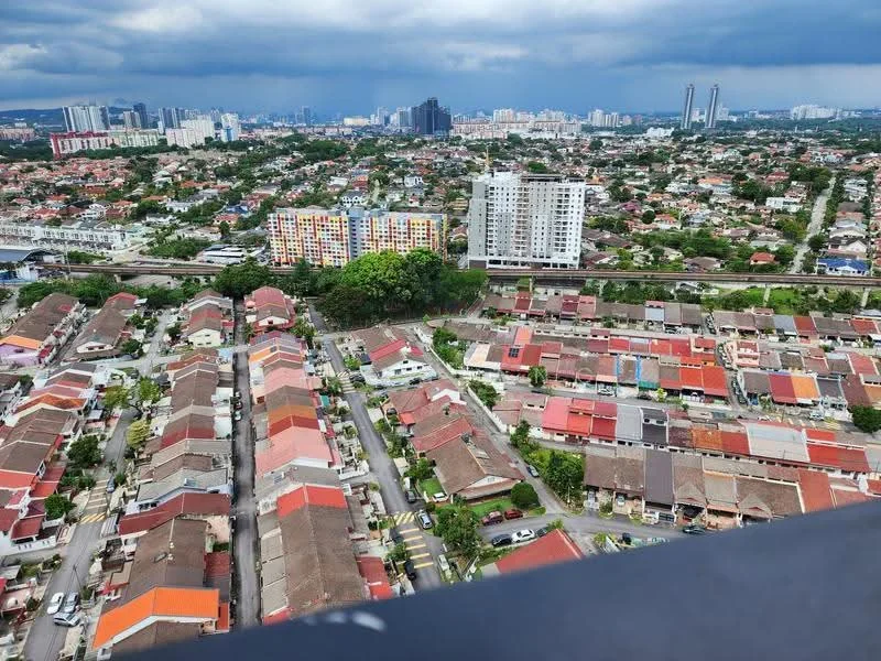 Exterior type: high-rise condominium; features: city skyline view, surrounded by residential areas, mixed architecture styles, greenery in the vicinity, multi-storey buildings, low-rise houses with red roofs, urban landscape, high-rise buildings in the background; style: modern.