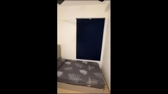 Bedroom features: queen-size bed, grey bedding with leaf pattern, white painted walls, light wood flooring, blackout roller blinds, ceiling fan; style: modern.