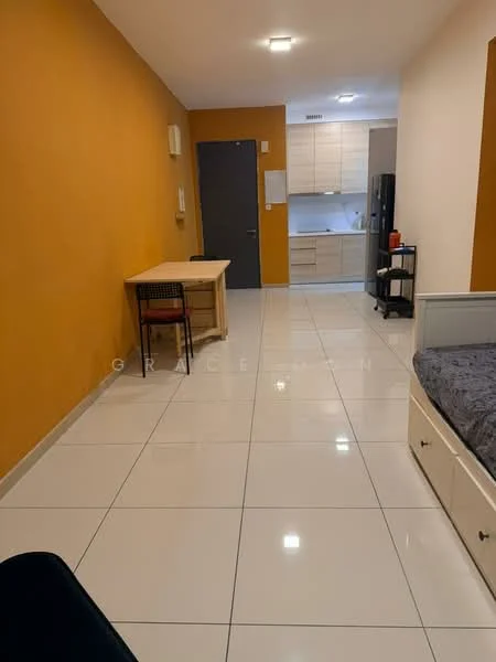 Room features: orange accent wall, white painted walls, glossy white tile flooring, recessed ceiling lights, dining table with one chair, grey upholstered bed frame, built-in cabinetry in kitchen, kitchen countertop, refrigerator visible in kitchen area, door leading to hallway, open layout; style: modern.