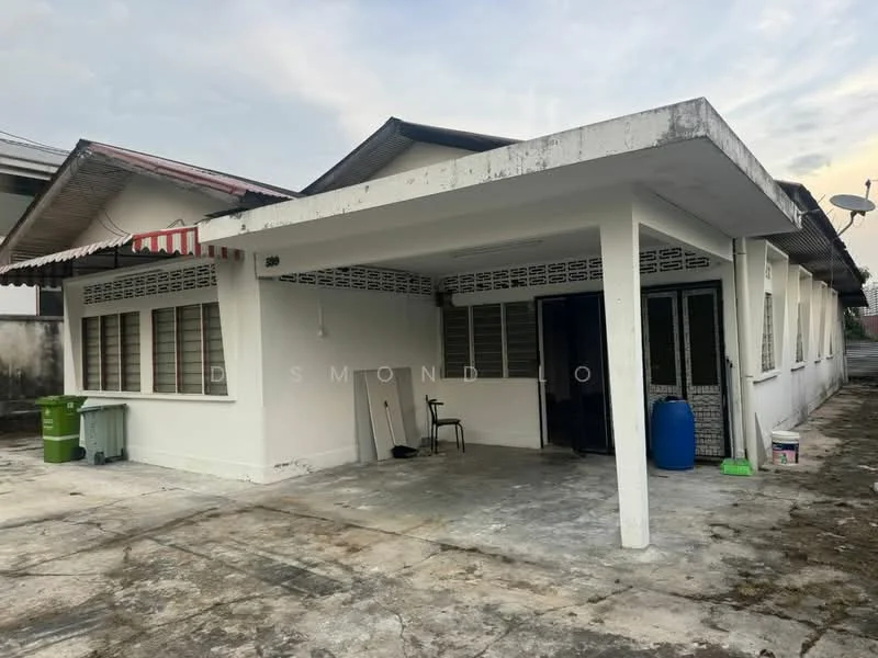 Exterior type: detached bungalow; features: white painted facade, flat roof, single-storey, manicured lawn, concrete driveway, window grilles, outdoor chair, green trash bin, blue water tank, satellite dish, awnings over windows; style: traditional.