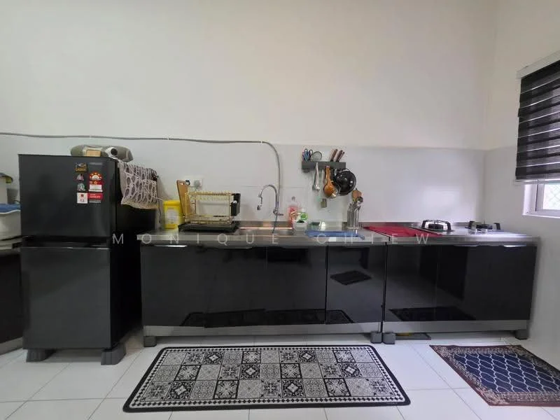 Kitchen features: black glossy cabinetry, white countertop, stainless-steel sink, chrome faucet, built-in stove, black refrigerator, microwave, kitchen rug with geometric pattern, window with black roller blinds, wall-mounted kitchen utensils, tile flooring; style: modern.