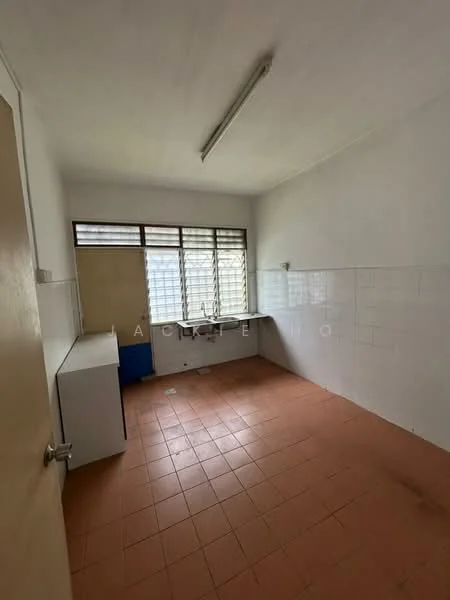 Room features: white painted walls, tile flooring in terracotta color, window with multiple panes, fluorescent ceiling light, built-in countertop, sink, empty space, no visible appliances.