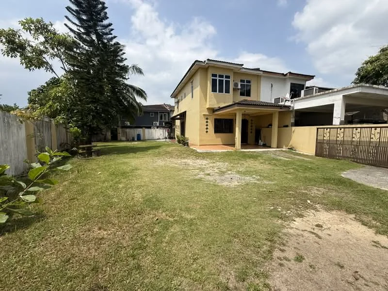 Exterior type: semi-detached house; features: yellow painted facade, two-storey structure, sloping roof, manicured lawn, paved pathway, surrounded by greenery, car porch, fence, outdoor space, large windows, balcony on upper floor; style: modern.