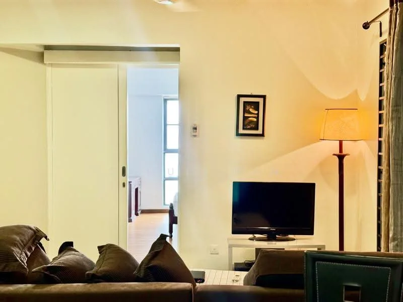Living features: brown fabric sofa, coffee table, wall-mounted TV, floor lamp, white painted walls, wooden flooring, curtains, decorative artwork; style: modern.
