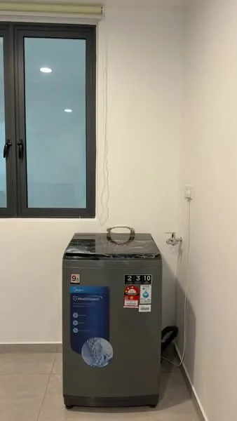 Laundry features: top-load washing machine in grey, window with black frame, white painted walls, grey tile flooring, water supply connection, power outlet.