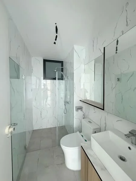 Bathroom features: white ceramic toilet, single-sink vanity with wood cabinet, white rectangular sink, chrome basin mixer faucet, framed mirror, walk-in shower with glass enclosure, rain shower head, marble tile walls, grey tile flooring, recessed downlights; style: modern.