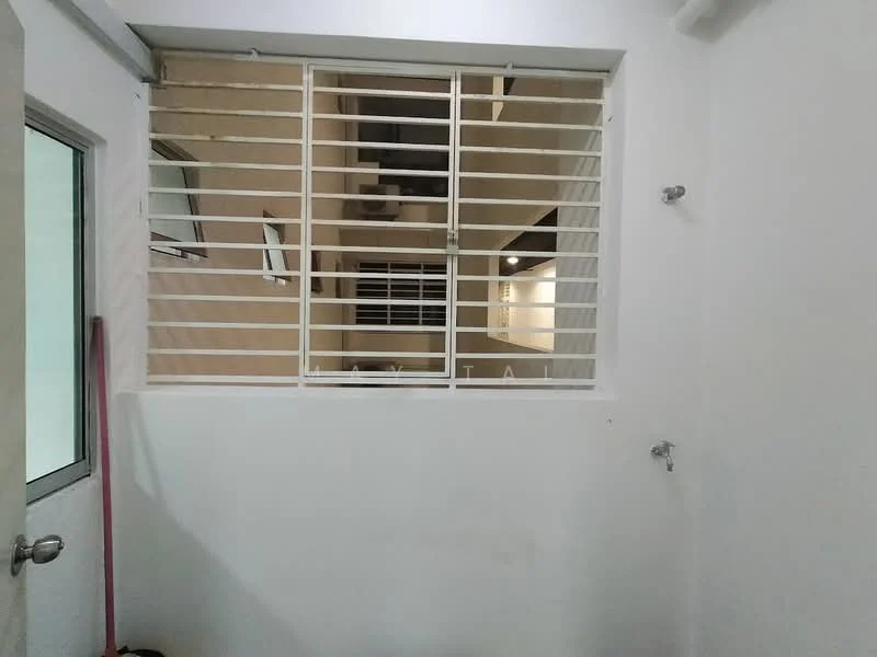 Room features: white painted walls, window with security grille, two wall-mounted faucets, light fixture on ceiling, neutral flooring.