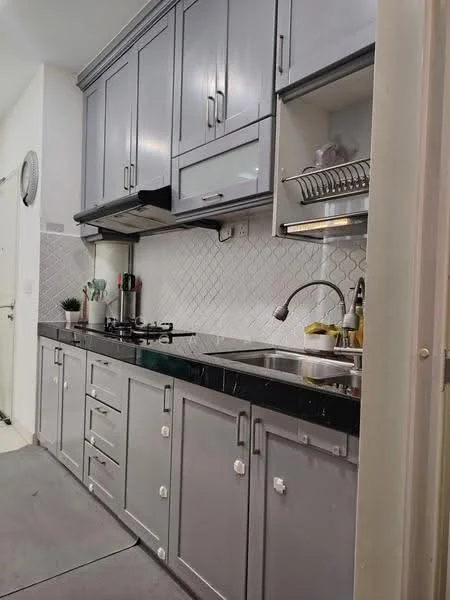 Kitchen features: grey cabinetry, black countertop, stainless-steel sink, chrome pull-down faucet, built-in gas stove, white backsplash with herringbone pattern, wall-mounted range hood, open shelving, kitchen utensils, small potted plant; style: modern.