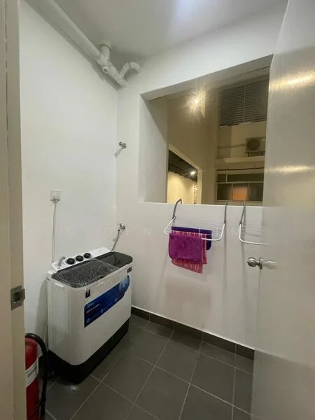 Laundry features: front-load washing machine, grey tiled flooring, white painted walls, wall-mounted clothes drying rack, fire extinguisher, window for natural light, plumbing pipes visible.