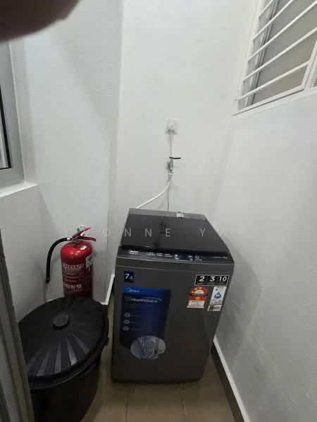 Laundry features: front-load washing machine in silver, water supply connection, fire extinguisher, black round trash bin, white painted walls, wood-look tile flooring, small window for ventilation.