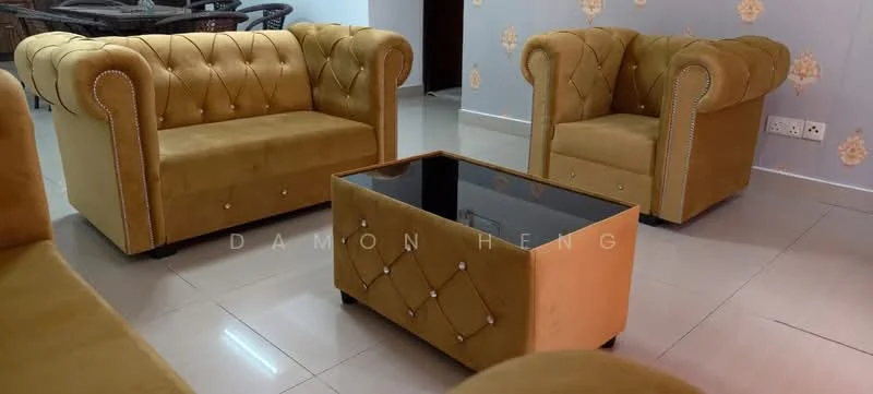 Living features: 2-seater sofa in mustard yellow, armchair in mustard yellow, glass-top coffee table with diamond tufting, cream tiled flooring, decorative wall with floral pattern, wall-mounted electrical outlets, recessed lighting, neutral wall color; style: modern.