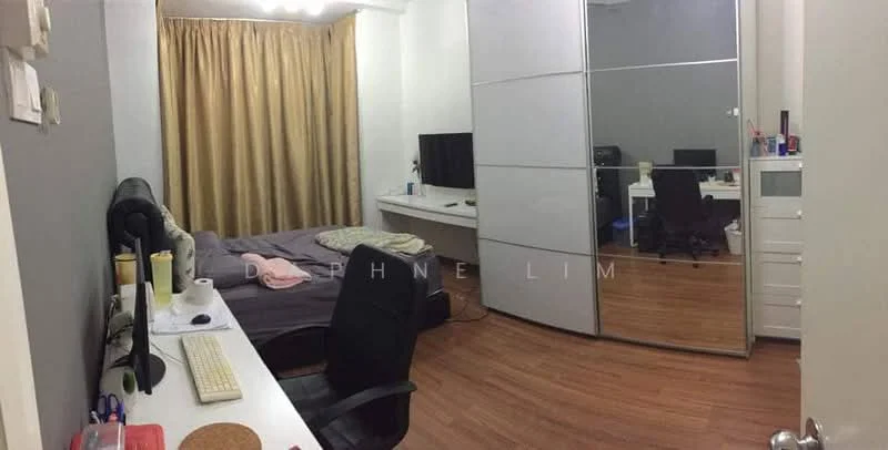 Bedroom features: queen-size bed with grey bedding, wooden flooring, grey painted walls, curtains in beige, built-in wardrobe with sliding doors, desk with white surface, black office chair, computer monitor on desk, keyboard on desk, decorative items on desk, wall-mounted TV, light fixture with multiple bulbs; style: modern.