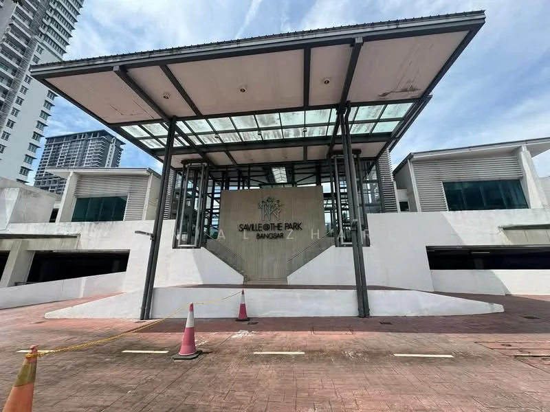 Exterior type: low-rise apartment block; features: glass canopy entrance, concrete facade, white painted facade, signage with 'Saville @ The Park Bangsar', paved driveway, surrounding greenery, parking area, modern architectural design; style: modern.