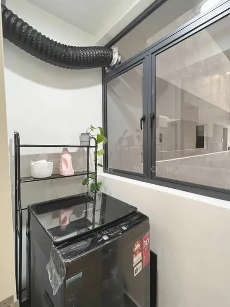 Laundry features: front-load washing machine, black glass top, metal shelving unit, decorative plant, white ceramic vase, pink bottle, black framed windows, exposed ducting; style: modern.