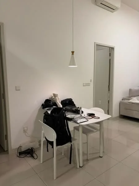Room features: white painted walls, glossy tile flooring, 1 pendant light, 1 wall-mounted split AC, small dining table with 4 white chairs, stack of clothes on the table, black backpack on the floor, electrical cords visible; style: modern.