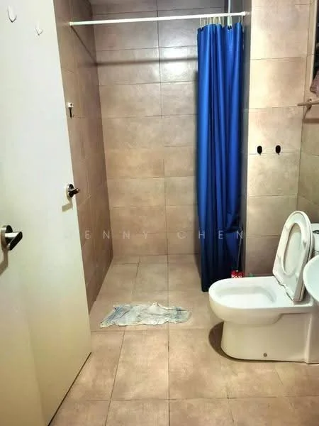 Bathroom features: beige tiled walls, beige tiled flooring, white toilet, shower area with curtain, blue shower curtain, wall-mounted towel rack, floor mat, no visible sink.