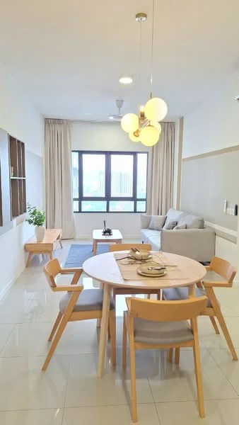 Living features: light grey fabric sofa, round wooden dining table, 4 wooden dining chairs with grey upholstery, pendant light fixture with three bulbs, floor-to-ceiling windows, sheer curtains, white painted walls, glossy white tile flooring, decorative wall shelf, area rug with geometric pattern, indoor plant in ceramic pot; style: modern; view: city.