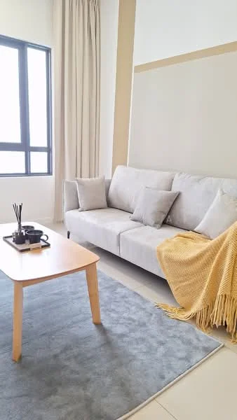 Living features: light grey fabric sofa, two decorative cushions, yellow knitted throw blanket, wooden coffee table, black decorative tray, incense holder, grey area rug, floor-to-ceiling window, sheer curtains, neutral painted walls, light tile flooring; style: modern.