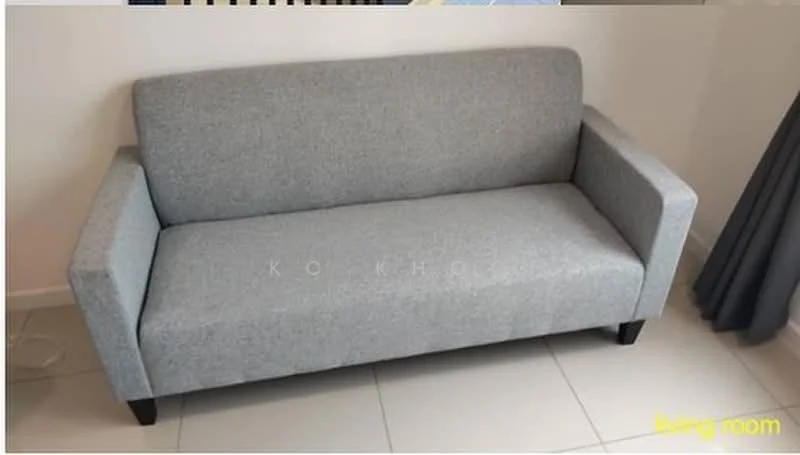 Living features: grey fabric 3-seater sofa, square armrests, dark wooden legs, tile flooring, light-colored walls, curtains, decorative wall, minimalist design; style: modern.