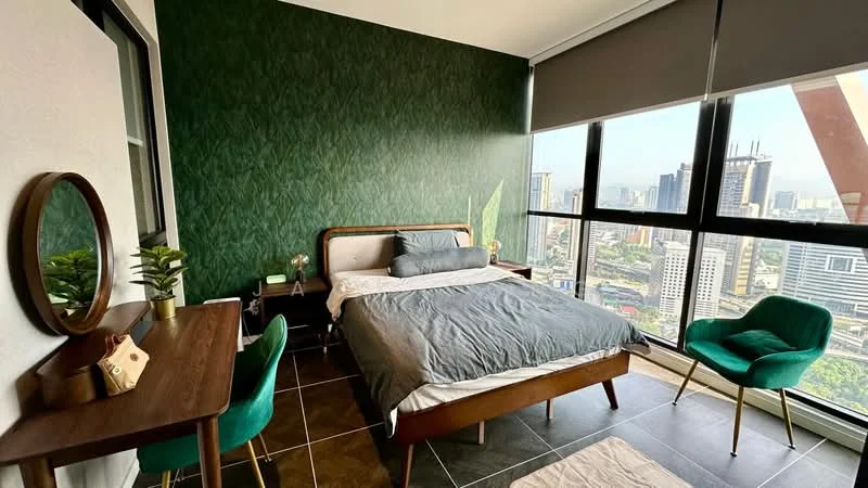 Bedroom features: green accent wallpaper, large floor-to-ceiling windows, queen-size bed with grey bedding, wooden bed frame, wooden bedside table, table lamp, green upholstered chair, wooden desk, decorative plant, dark tiled flooring, roller blinds; style: modern; view: city.