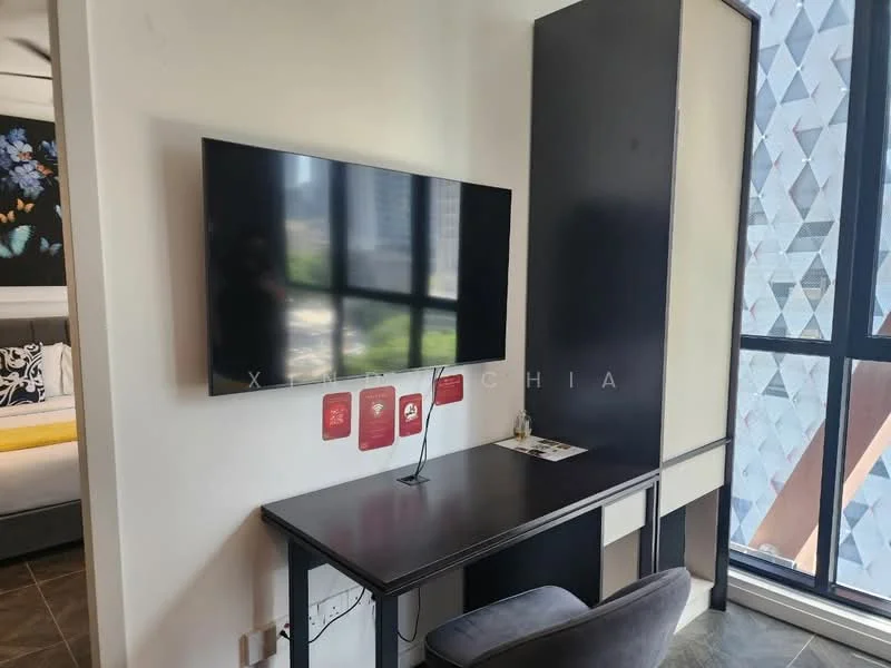 Room features: wall-mounted TV, black desk, grey upholstered chair, large window with city view, decorative wall art, light-colored cabinetry, floor-to-ceiling window, laminate flooring; style: modern; view: city.
