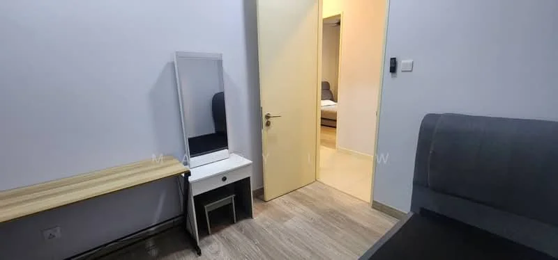 Room features: light grey painted walls, laminate flooring, wooden desk, white vanity with mirror, grey upholstered chair, door leading to another room, soft lighting, minimalist decor; style: modern.