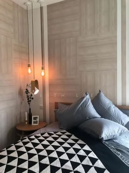 Bedroom features: wood paneling on walls, grey painted walls, hanging pendant lights, queen-size bed with grey bedding, decorative throw pillows, round wooden bedside table, framed photo on bedside table, decorative plant on bedside table, geometric patterned bedspread; style: modern.
