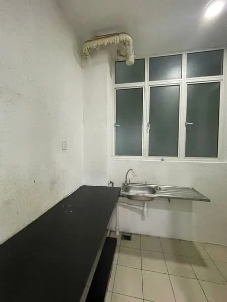 Kitchen features: black countertop, stainless-steel sink, wall-mounted faucet, white painted walls, tile flooring, three vertical windows, exposed plumbing, under-cabinet lighting.