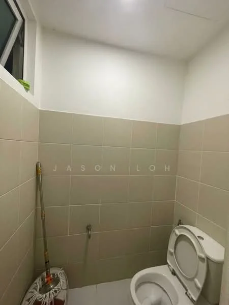 Bathroom features: white painted walls, light grey tiled walls, one-piece toilet, toilet paper holder, window for natural light, mop and bucket, floor tiles, plumbing fixtures.