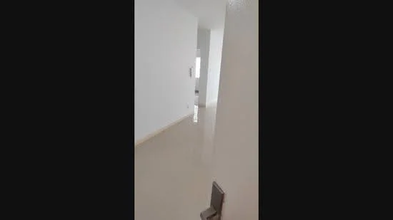 Room features: white painted walls, glossy tile flooring, door frame, door handle, natural light from doorway.