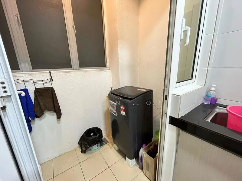 Laundry features: white painted walls, tile flooring, window with glass panes, washing machine, sink with pink basin, hanging rack for clothes, plastic laundry basket, cleaning supplies, small garbage bin.