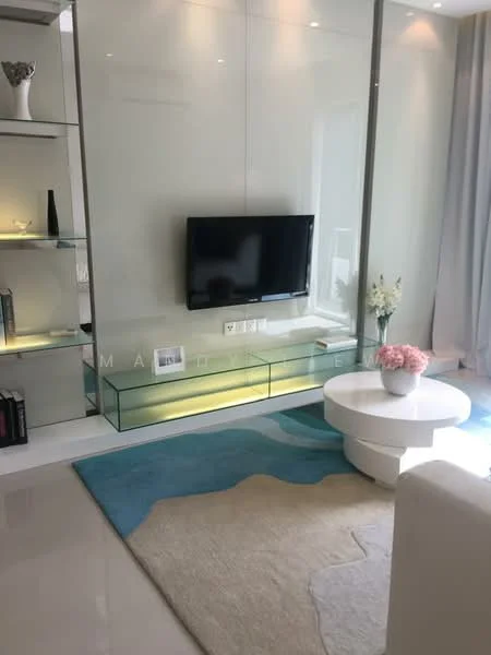 Living features: wall-mounted TV, glass TV console, light-colored area rug, white circular coffee table, built-in shelving unit, decorative vase, potted plant, floor-to-ceiling windows with sheer curtains, recessed lighting, neutral wall color, polished tile flooring; style: modern.