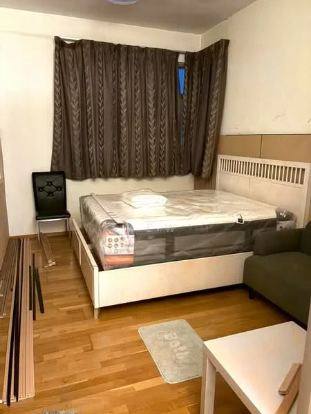 Bedroom features: wooden flooring, white painted walls, brown curtains, queen-size bed with mattress, bed frame with headboard, small white side table, green fabric sofa, black dining chair, area rug, exposed wall with wooden paneling, bedside lamp, bed linens; style: modern.