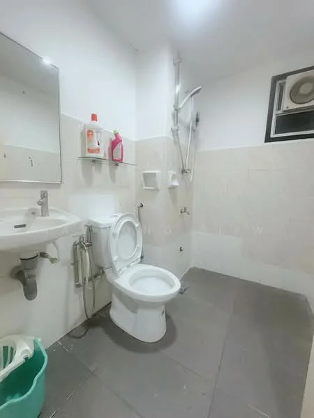 Bathroom features: white ceramic toilet, single-sink vanity with mirror, chrome basin mixer faucet, shower with wall-mounted shower head, tile cladding on walls, grey floor tiles, exhaust fan, toilet paper holder, soap dispenser, plastic waste bin.