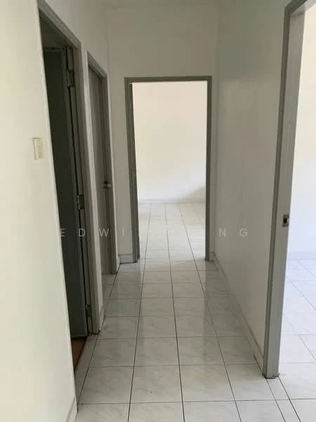 Hallway features: white painted walls, white tiled flooring, grey door frames, two doors on the left, one door on the right, natural light from adjacent room, straight corridor layout.