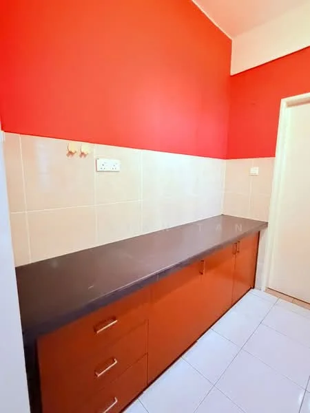 Room features: red painted walls, cream tiled walls, black countertop, brown cabinetry with drawers, white tiled flooring, single wall-mounted electrical outlet, doorway leading to another room; style: modern.